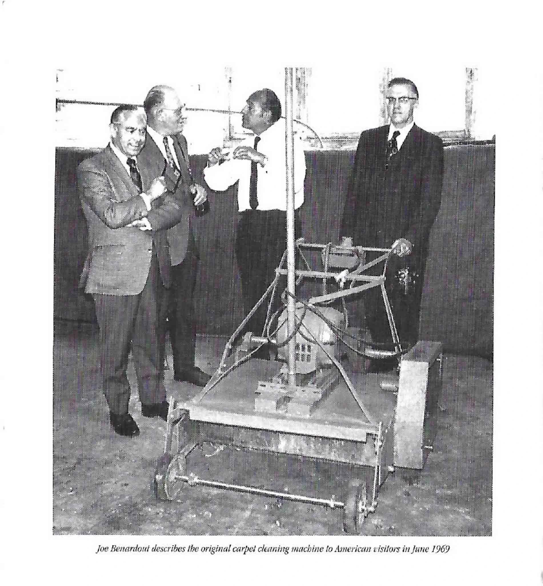 Joe Benardout describes the original carpet cleaning machine to American visitors, June 1969