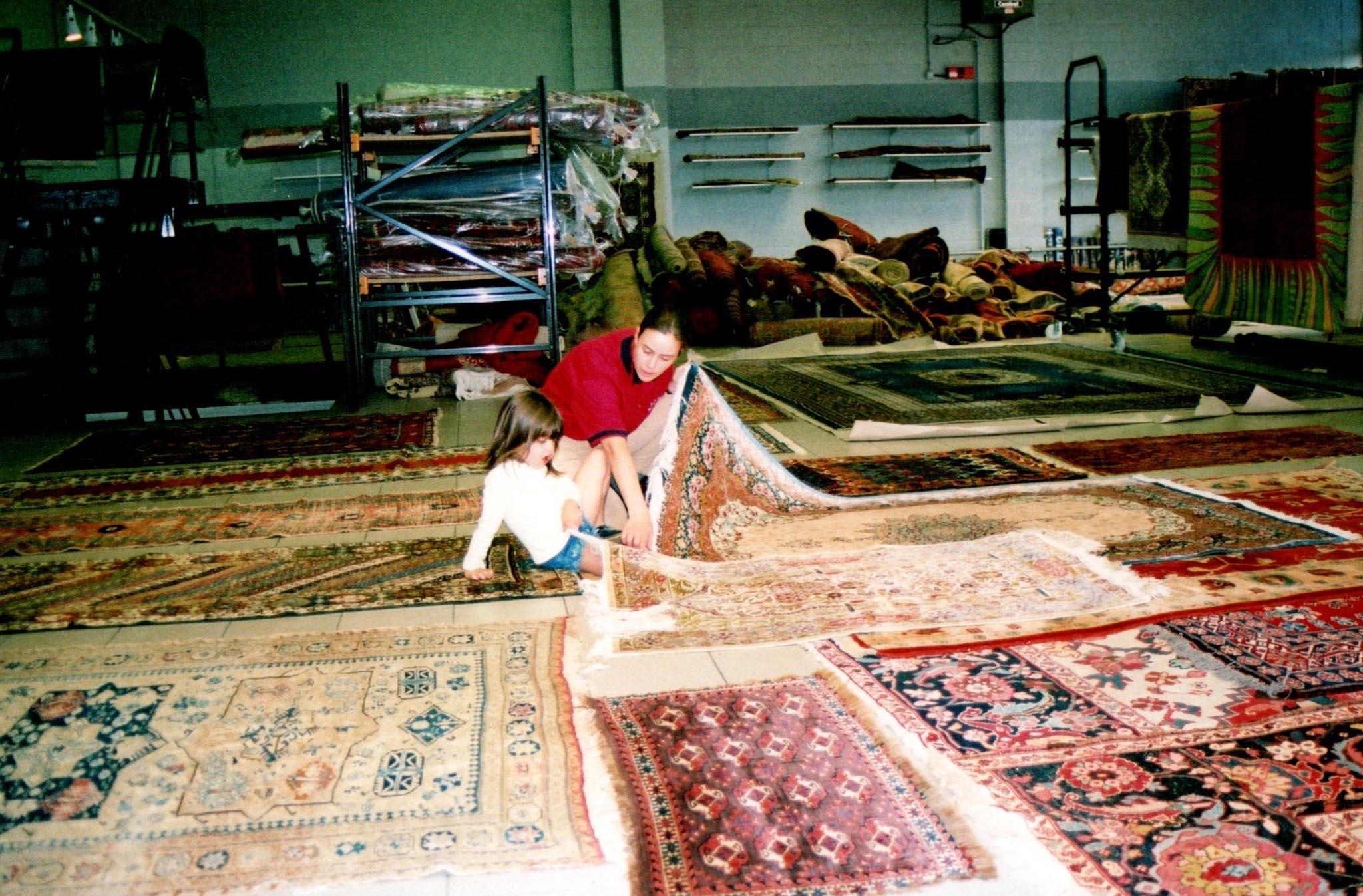 My mother and I in the barn with all the carpets